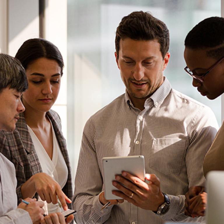 Business professionals looking at tablet