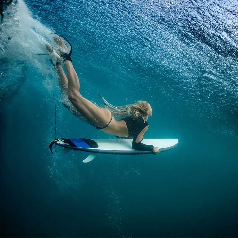 Girl diving on surfboard